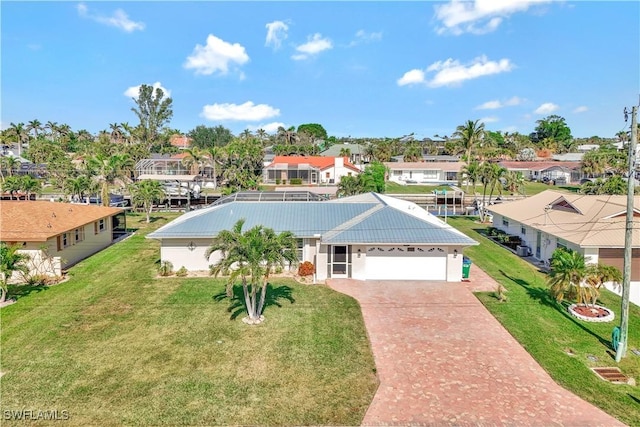 view of front of property with a garage and a front yard