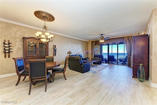 dining area featuring ornamental molding, ceiling fan with notable chandelier, and light wood-type flooring