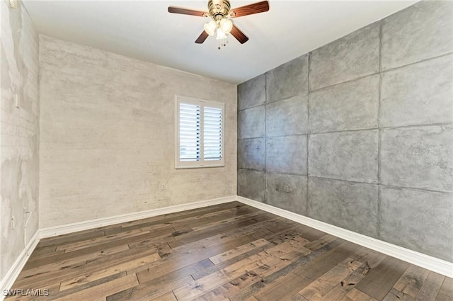 empty room featuring ceiling fan and dark hardwood / wood-style flooring