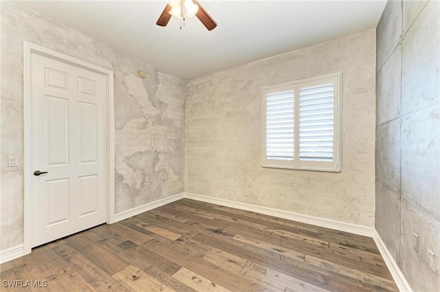 spare room with wood-type flooring and ceiling fan