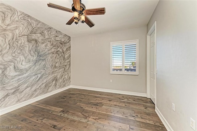 spare room with ceiling fan and dark hardwood / wood-style flooring