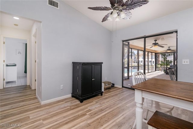 dining space with lofted ceiling, ceiling fan, and light wood-type flooring