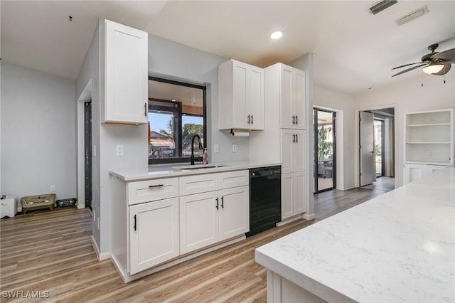 kitchen featuring a wealth of natural light, black dishwasher, sink, and white cabinets