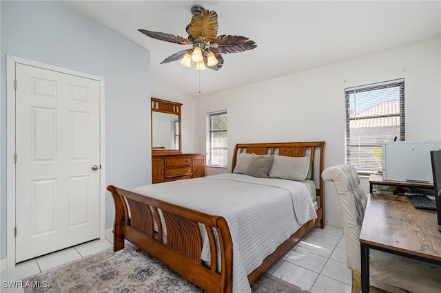 bedroom with multiple windows, lofted ceiling, light tile patterned floors, and ceiling fan