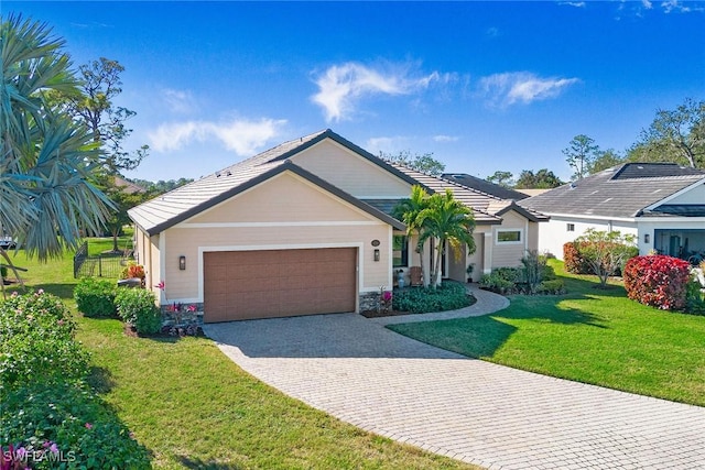 view of front of house with a garage and a front lawn