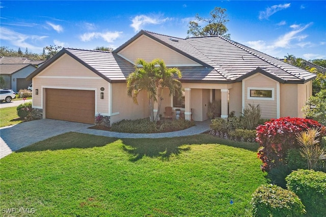 view of front of home featuring a garage and a front yard