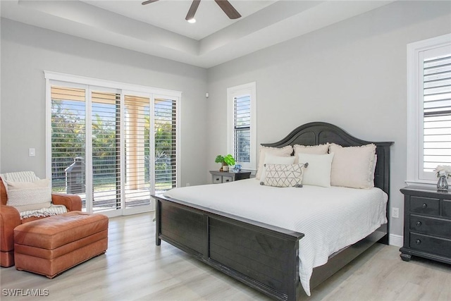 bedroom with multiple windows, access to exterior, light hardwood / wood-style flooring, and ceiling fan