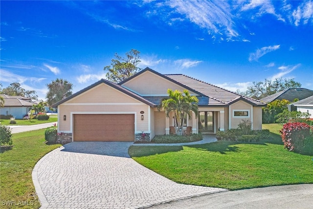 view of front of home featuring a garage and a front lawn