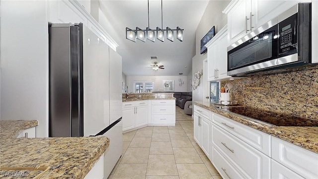 kitchen featuring white cabinets and stone counters