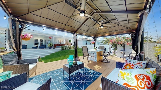 view of patio with an outdoor living space, a gazebo, ceiling fan, and a wooden deck