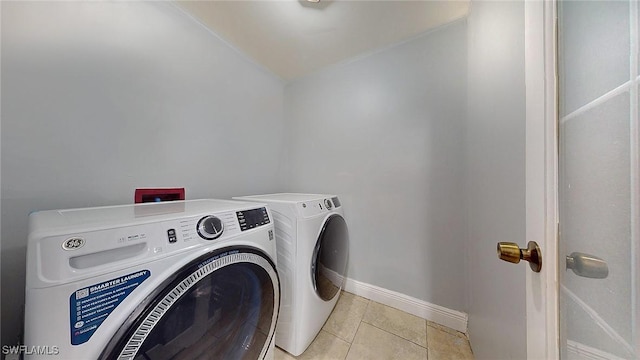 washroom with light tile patterned flooring and separate washer and dryer