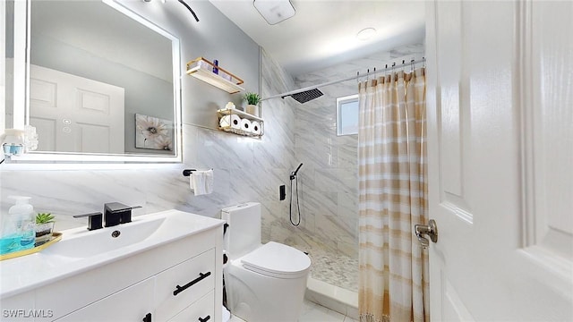 bathroom with vanity, curtained shower, tile walls, and toilet