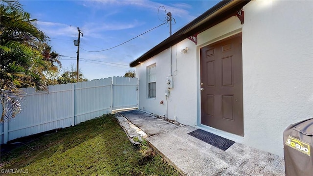 doorway to property featuring a yard