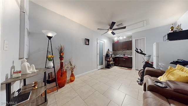 tiled bedroom with white refrigerator and ceiling fan