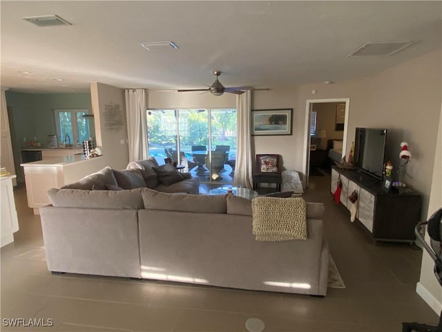 tiled living room featuring sink and ceiling fan