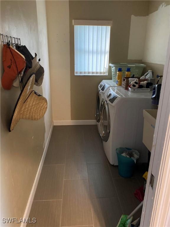 clothes washing area with independent washer and dryer