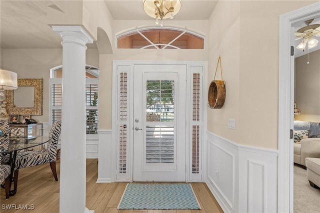 entryway featuring light hardwood / wood-style floors and ornate columns