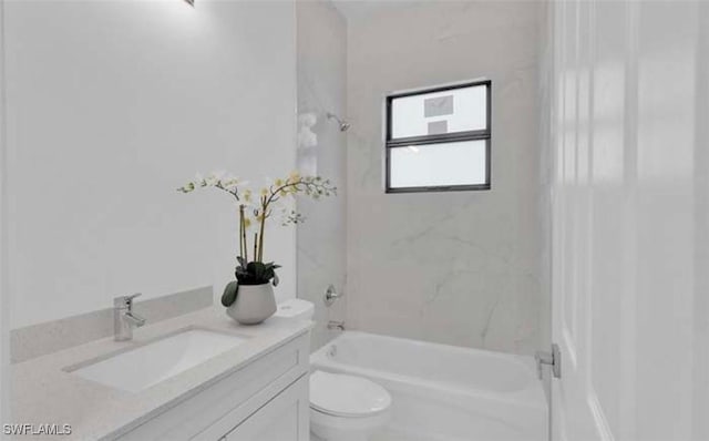 full bathroom featuring vanity, tiled shower / bath, and toilet