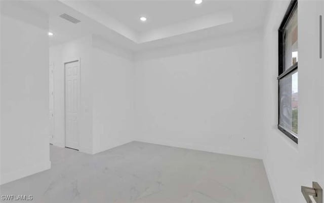 empty room with a raised ceiling