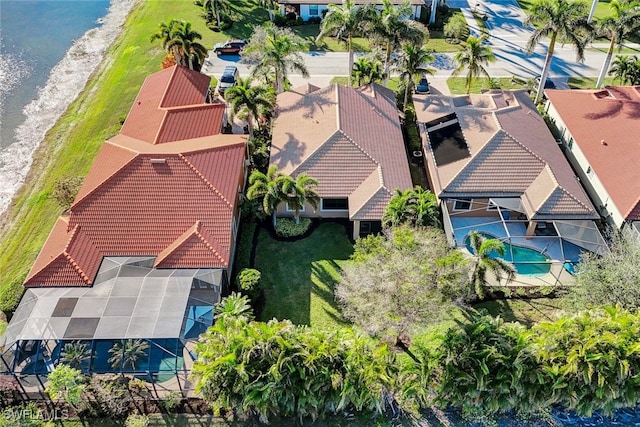 drone / aerial view featuring a water view and a beach view