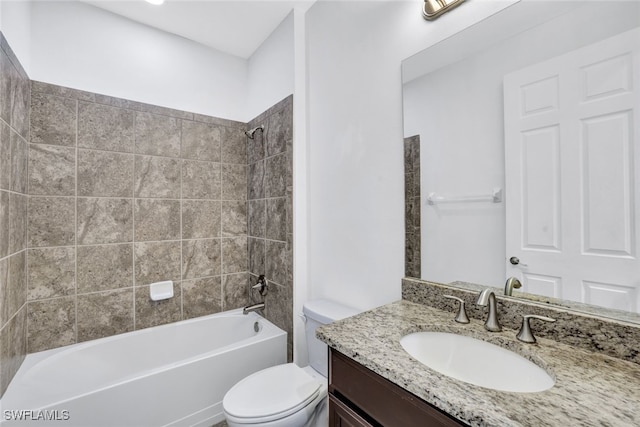 full bathroom with tiled shower / bath, vanity, and toilet