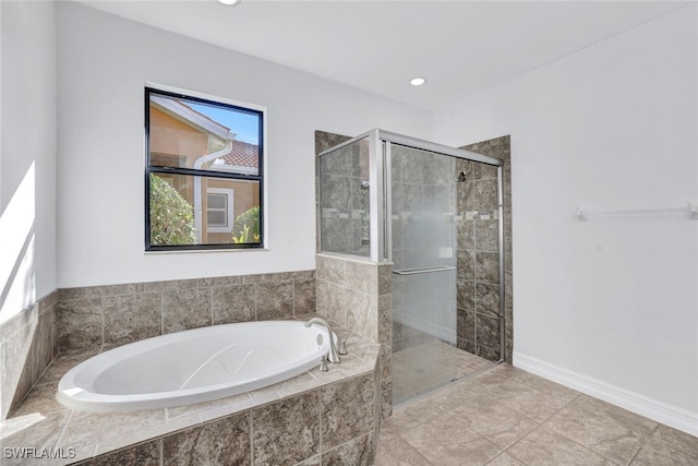 bathroom with separate shower and tub