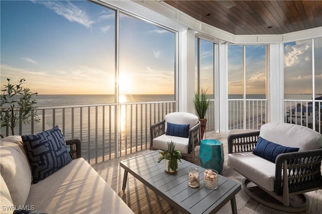 sunroom / solarium with a water view and wooden ceiling