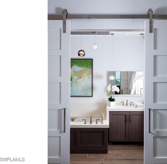 bathroom featuring vanity, a bathtub, and hardwood / wood-style floors