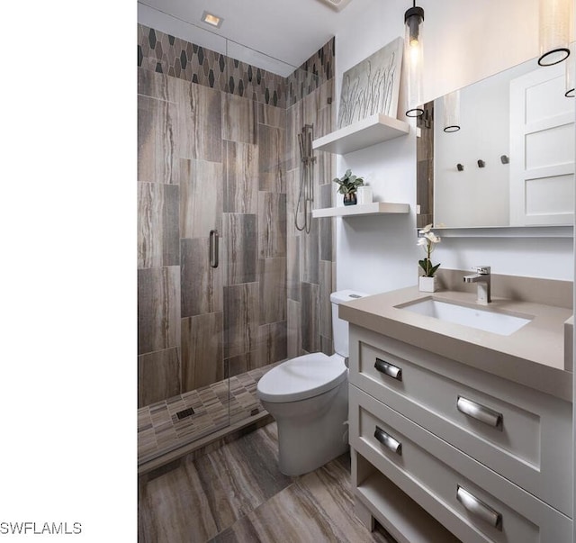 bathroom featuring vanity, hardwood / wood-style flooring, toilet, and walk in shower