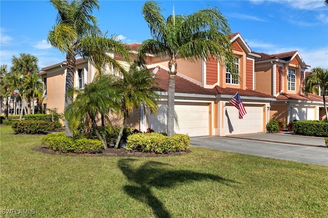 view of front facade with a garage and a front lawn