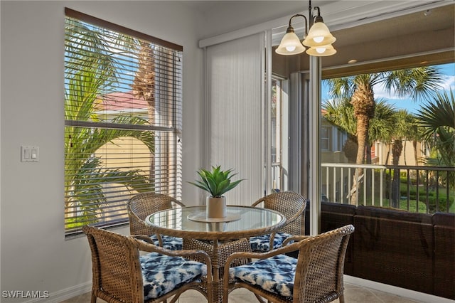 dining room featuring a healthy amount of sunlight and an inviting chandelier