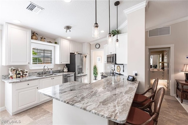 kitchen featuring sink, white cabinetry, light stone counters, kitchen peninsula, and stainless steel appliances