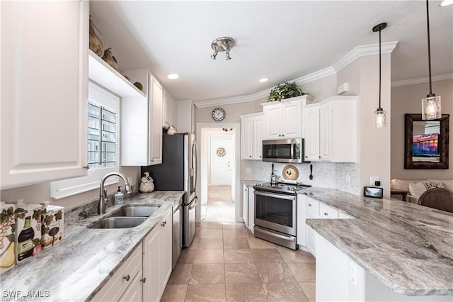 kitchen featuring sink, appliances with stainless steel finishes, white cabinetry, light stone counters, and decorative light fixtures