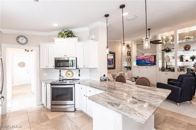 kitchen featuring pendant lighting, tasteful backsplash, white cabinetry, kitchen peninsula, and stainless steel appliances