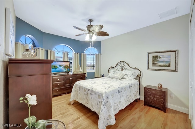 bedroom with ceiling fan and light wood-type flooring