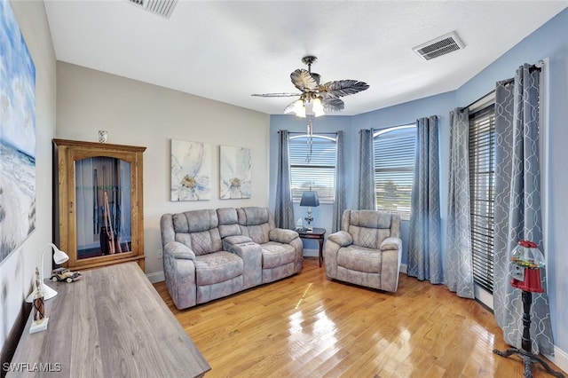 living room featuring ceiling fan and light wood-type flooring