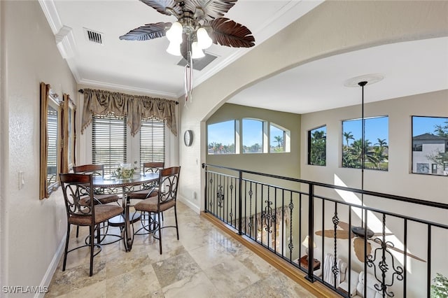 dining area featuring ornamental molding and ceiling fan