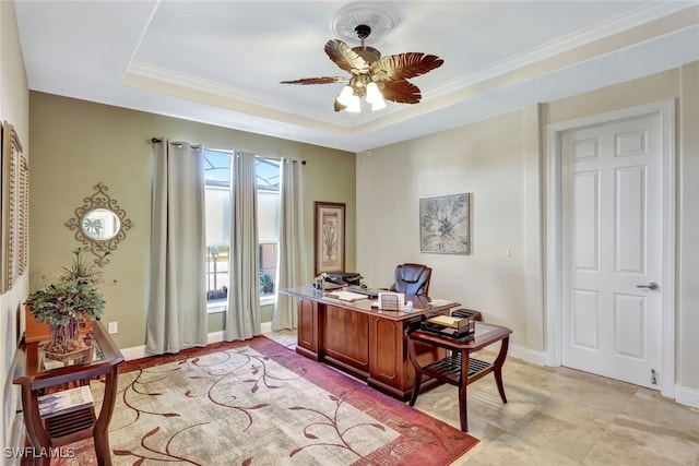 office space featuring a tray ceiling, ornamental molding, and ceiling fan