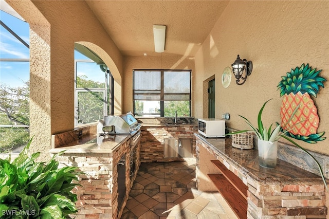 view of patio with area for grilling and sink