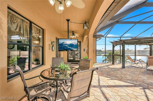 view of patio featuring a lanai and ceiling fan