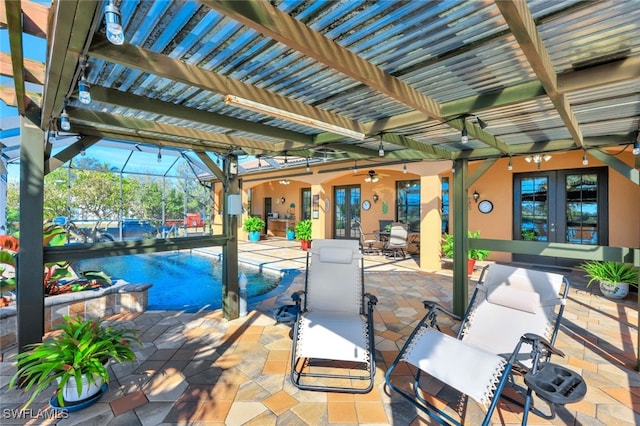 view of patio / terrace with a lanai, french doors, and ceiling fan