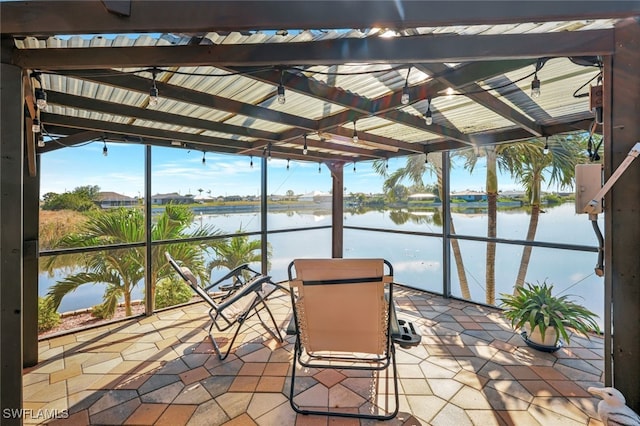 unfurnished sunroom with a water view