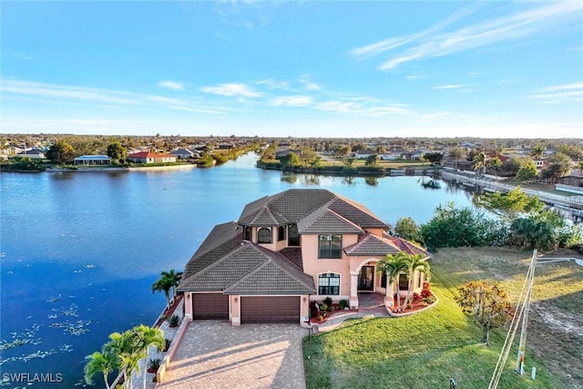 birds eye view of property with a water view