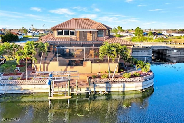 exterior space featuring a balcony and a water view