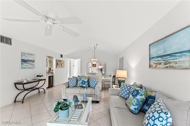 living room featuring ceiling fan, vaulted ceiling, and light tile patterned floors