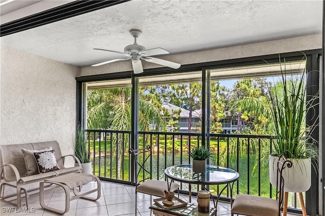 sunroom featuring ceiling fan