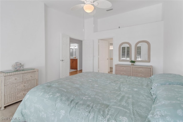 bedroom featuring ceiling fan and a towering ceiling