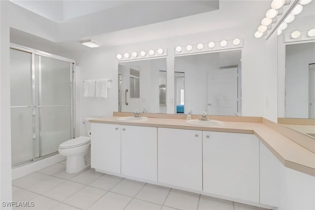 bathroom with walk in shower, vanity, toilet, and tile patterned flooring