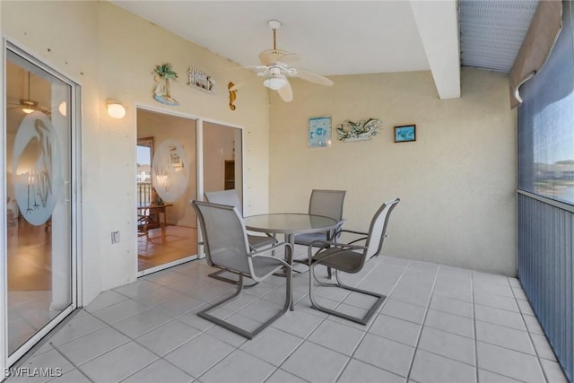 interior space with ceiling fan and lofted ceiling with beams