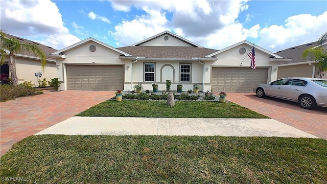 ranch-style house with a garage and a front yard